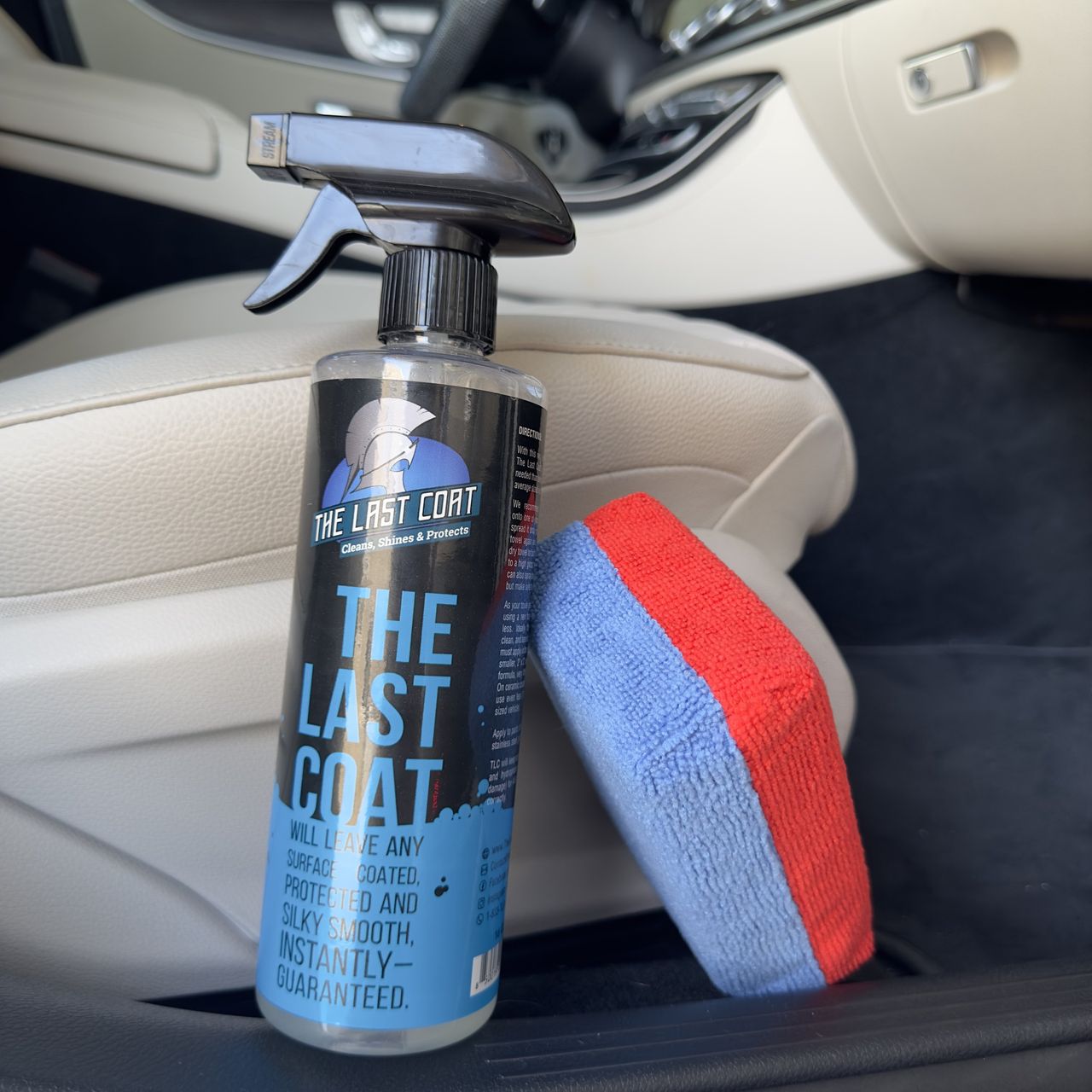 The Last Coat 2.0 bottle and a microfiber applicator inside a car