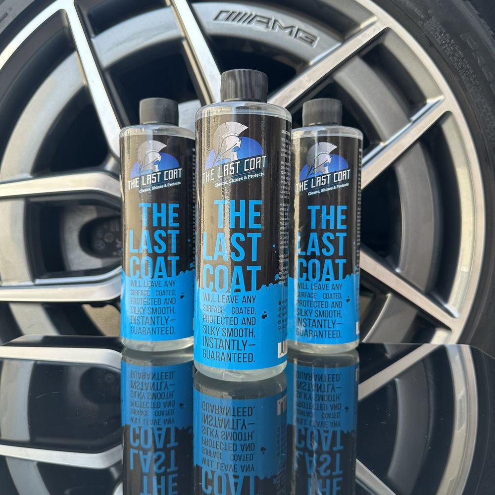 The Last Coat bottles in front of a car wheel